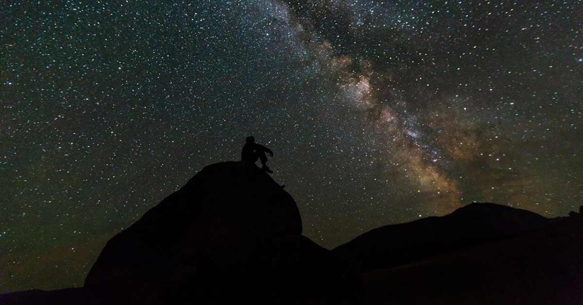 Stargazers beneath a starry night sky